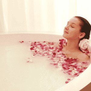 woman soaking in bath as new self-care ritual